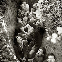 Children in a Kent hopfield take cover during a dog-fight overhead. Children in a Kent hopfield take cover during a dog-fight overhead.