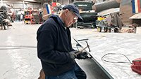 Robbie applying his 50 years of panel beating skills  to repair a section of the port wing.
