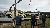 Whilst the starboard wing is being mounted, museum volunteers are mounting the starboard tail-wing. 