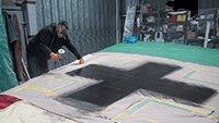 Julian spraying the dark grey of the Balkan cross. 